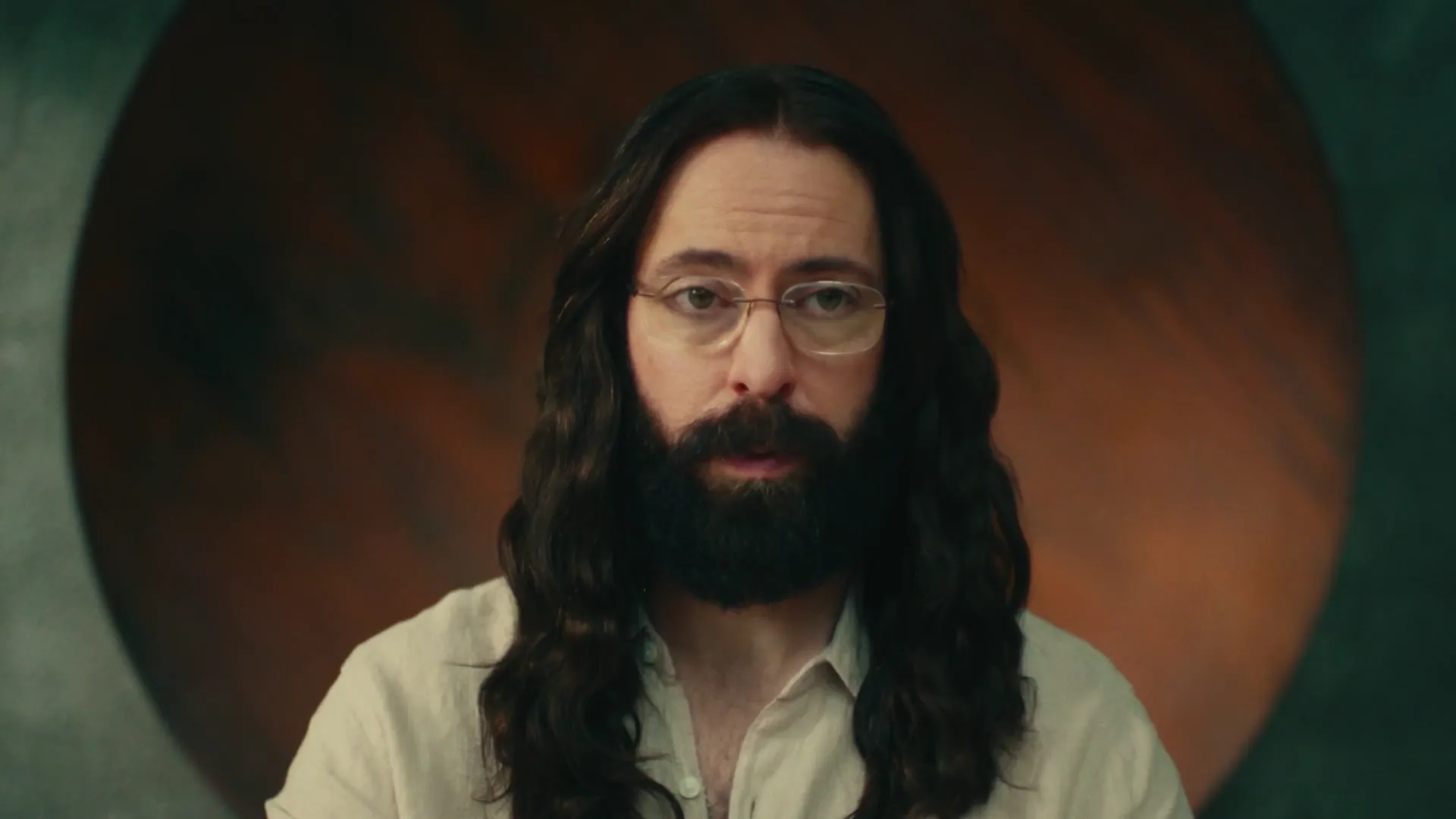 Long-haired bearded man in white linen